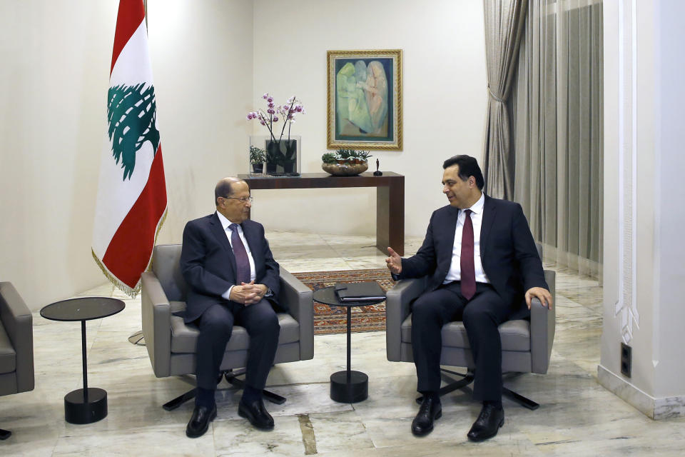 Lebanese President Michel Aoun, left, meets with Prime Minister-Designate Hassan Diab at the Presidential Palace in Baabda, east of Beirut,, Lebanon, Tuesday, Jan. 21, 2020. (AP Photo/Bilal Hussein)