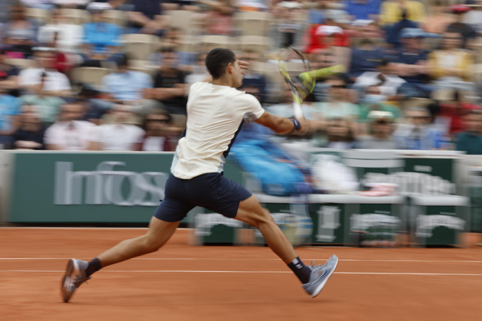 Spain's Carlos Alcaraz volleys the ball to Albert Ramos-Vinolas during their second round match of the French Open tennis tournament at the Roland Garros stadium Wednesday, May 25, 2022 in Paris. (AP Photo/Jean-Francois Badias)