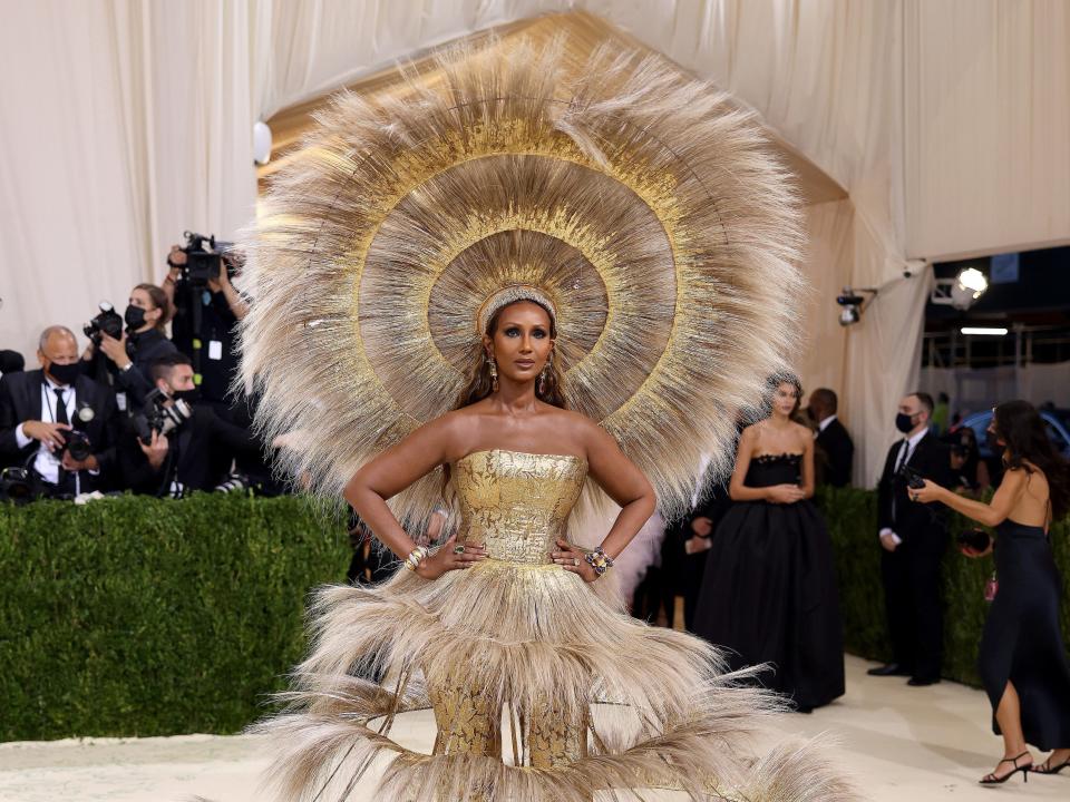 Iman wears a tiered dress and matching headpiece at the Met Gala.