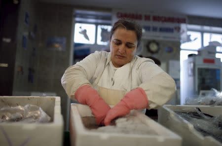 Sonia Silva, 41, works at her fish stall in Almada's market, near Lisbon, Portugal November 18, 2015. REUTERS/Rafael Marchante