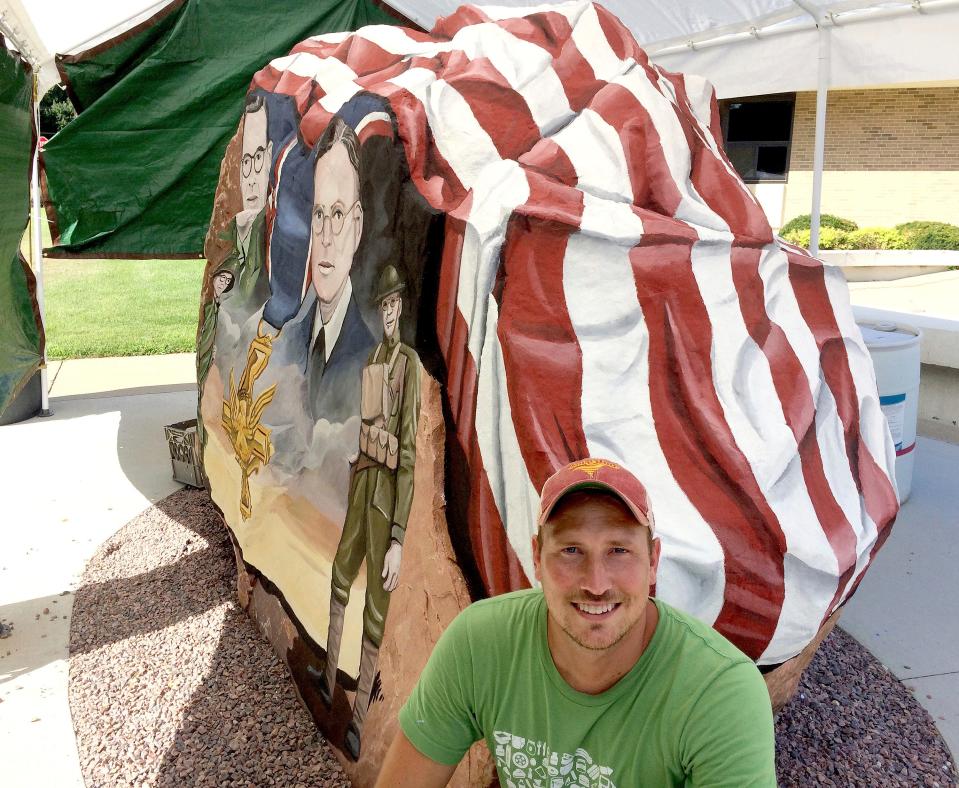 Artist Ray "Bubba" Sorensen II is shown at the Cherokee County Freedom Rock mural outside the county courthouse in Cherokee, Iowa, in July 2017. Sorensen has been placing Freedom Rock murals across Iowa since 2013 to honor service members.