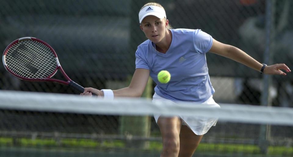 Kara Molony-Hussey returns a shot at the net during a doubles-match win with her partner, sister Lyndsey Molony, in the Thomas E. Price Metropolitan Tennis tournament, Monday, July 15, 2002.