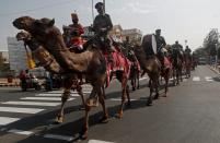 Border Security Force (BSF) soldiers ride their camels as they take part in a rehearsal for a road show ahead of the visit of U.S. President Donald Trump, in Ahmedabad