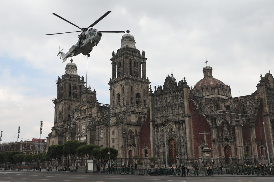 VARIOUS CITIES, MEXICO - SEPTEMBER 16: A Mexican Air Force helicopter performs a ceremonial flight during the Independence Day military parade at Zocalo Square on September 16, 2020 in Various Cities, Mexico. This year El Zocalo remains closed for general public due to coronavirus restrictions. Every September 16 Mexico celebrates the beginning of the revolution uprising of 1810. (Photo by Hector Vivas/Getty Images)