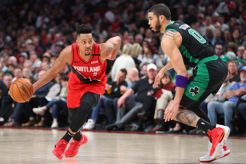 PORTLAND, OREGON - FEBRUARY 25: CJ McCollum #3 of the Portland Trail Blazers dribbles against Jayson Tatum #0 of the Boston Celtics in the fourth quarter during their game at Moda Center on February 25, 2020 in Portland, Oregon. NOTE TO USER: User expressly acknowledges and agrees that, by downloading and or using this photograph, User is consenting to the terms and conditions of the Getty Images License Agreement. (Photo by Abbie Parr/Getty Images)