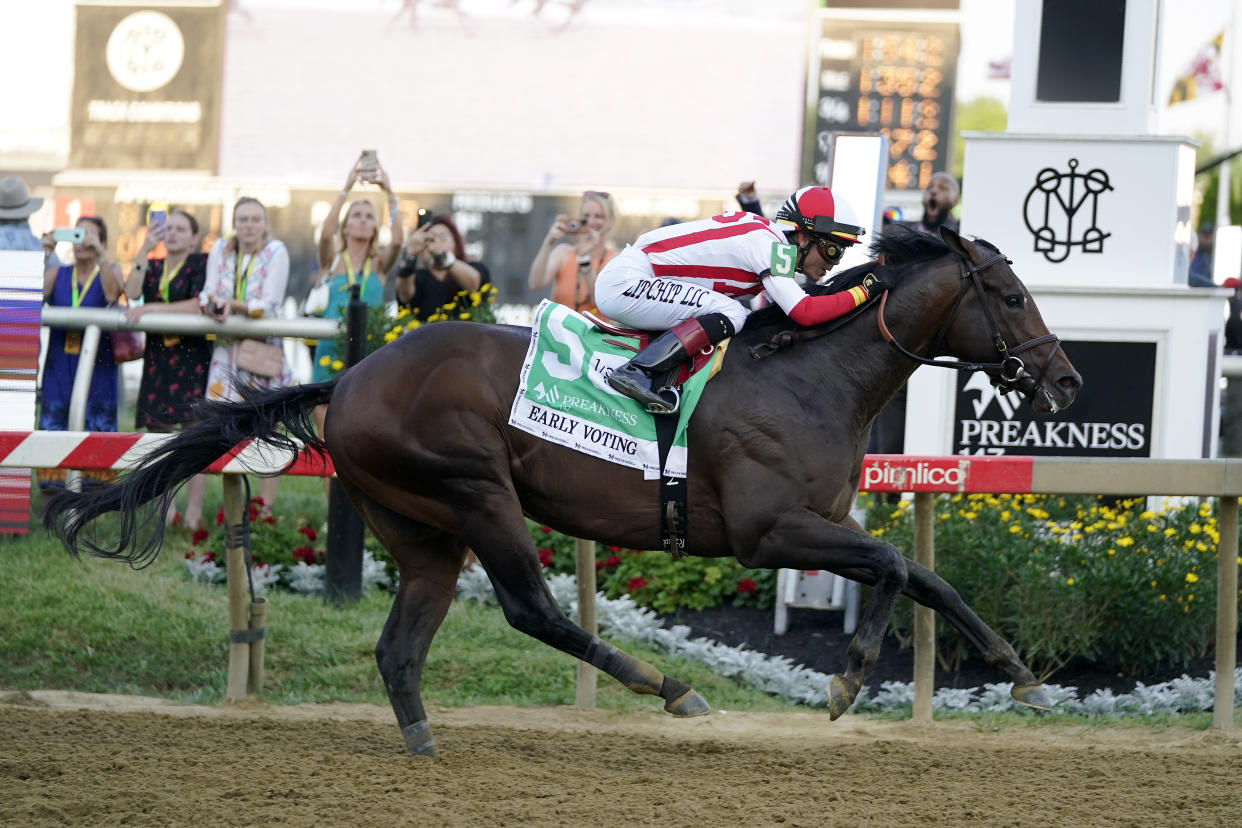 Jose Ortiz atop Early Voting wins the 147th running of the Preakness Stakes horse race at Pimlico Race Course, Saturday, May 21, 2022, in Baltimore. (AP Photo/Julio Cortez)