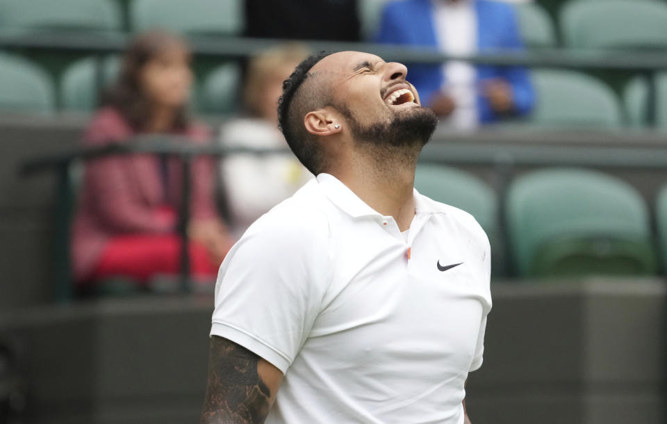 Australia's Nick Kyrgios celebrates winning the men's singles first round match against Ugo Humbert of France on day three of the Wimbledon Tennis Championships in London, Wednesday June 30, 2021. (AP Photo/Alberto Pezzali)