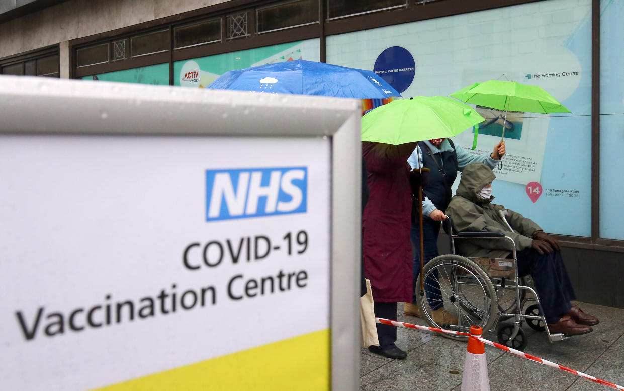 People queue in bad weather to enter a COVID-19 vaccination centre in Folkestone, Kent, during England's third national lockdown to curb the spread of coronavirus. Picture date: Friday January 29, 2021. (Photo by Gareth Fuller/PA Images via Getty Images)