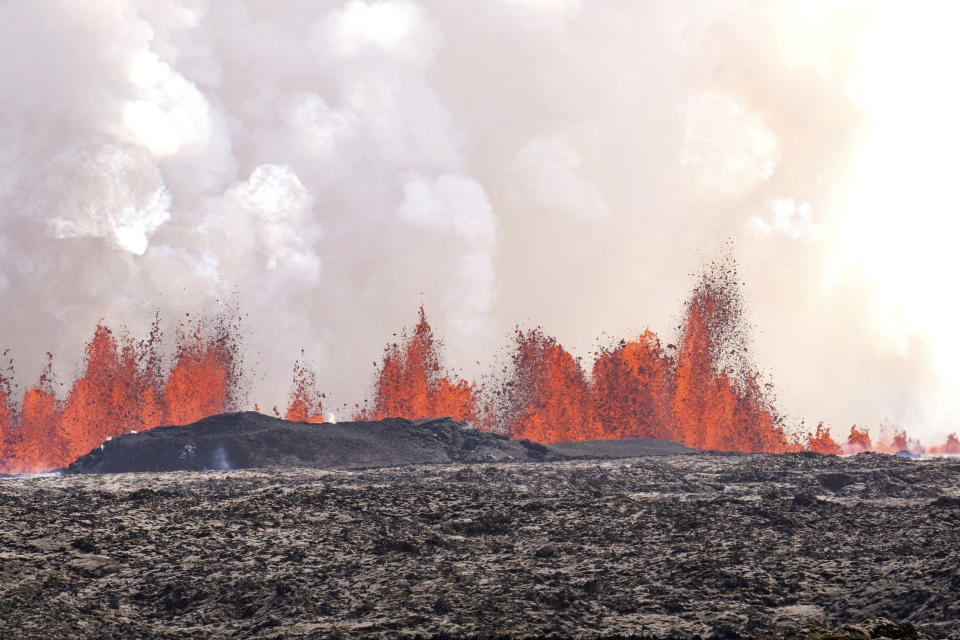 A volcano spews lava in Grindavik, Iceland, Wednesday, Wednesday, May 29, 2024. A volcano in southwestern Iceland is erupting, spewing red streams of lava in its latest display of nature's power. A series of earthquakes before the eruption Wednesday triggered the evacuation of the popular Blue Lagoon geothermal spa. The eruption began in the early afternoon north of Grindavik, a coastal town of 3,800 people that was also evacuated. (AP Photo/Marco di Marco)