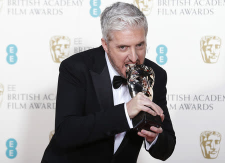 Anthony McCarten celebrates after winning best adapted screenplay for "The Theory of Everything" at the British Academy of Film and Arts (BAFTA) awards ceremony at the Royal Opera House in London February 8, 2015. REUTERS/Suzanne Plunkett