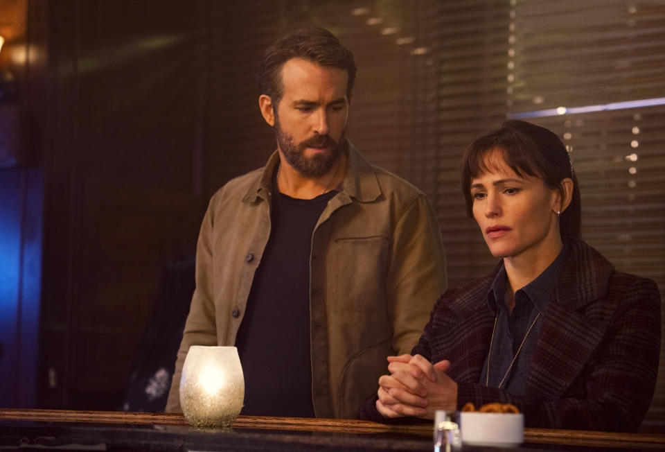 This image released by Netflix shows Ryan Reynolds, left, and Jennifer Garner in a scene from "The Adam Project." (Doane Gregory/Netflix via AP)