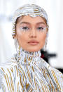 <p> An epic memorable beauty moment from the 2019 Met Gala, Gigi Hadid’s makeup artist Erin Parsons revealed on Instagram that she created this standout look by applying individual white feathers to the supermodel’s lashes, paired with a muted brown-pink lip. </p>