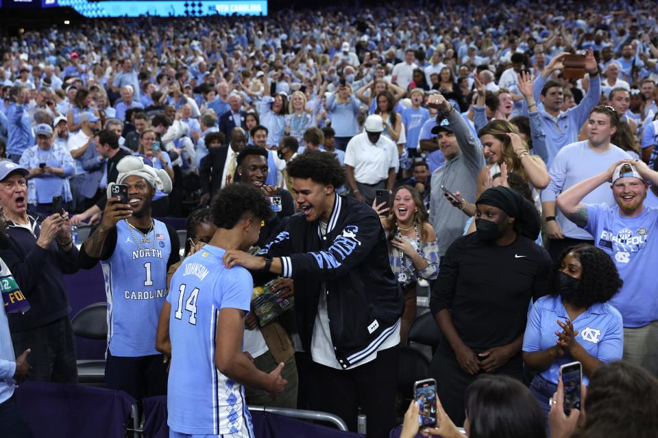 NEW ORLEANS, LOUISIANA - APRIL 02: Puff Johnson #14 of the North Carolina Tar Heels celebrates with his brother Cameron Johnson after defeating the Duke Blue Devils 81-77 in the second half of the game during the 2022 NCAA Men's Basketball Tournament Final Four semifinal at Caesars Superdome on April 02, 2022 in New Orleans, Louisiana.