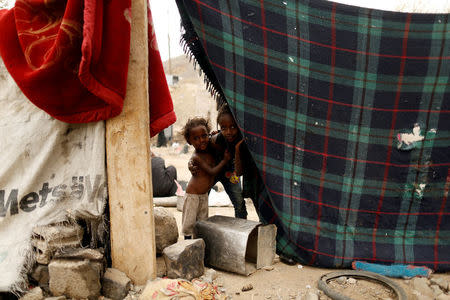 Children displaced from the Red Sea port city of Hodeidah stand outside a house where they live on the outskirts of Sanaa, Yemen July 10, 2018. REUTERS/Khaled Abdullah