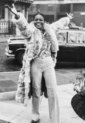 Portrait of Academy Award winning American actress Cicely Tyson smiling and raising her arms in the air during a visit to London, February 19th 1973.