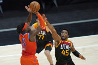 Oklahoma City Thunder forward Luguentz Dort (5) shoots as Utah Jazz guard Donovan Mitchell (45) defends during the second half of an NBA basketball game Tuesday, April 13, 2021, in Salt Lake City. (AP Photo/Rick Bowmer)