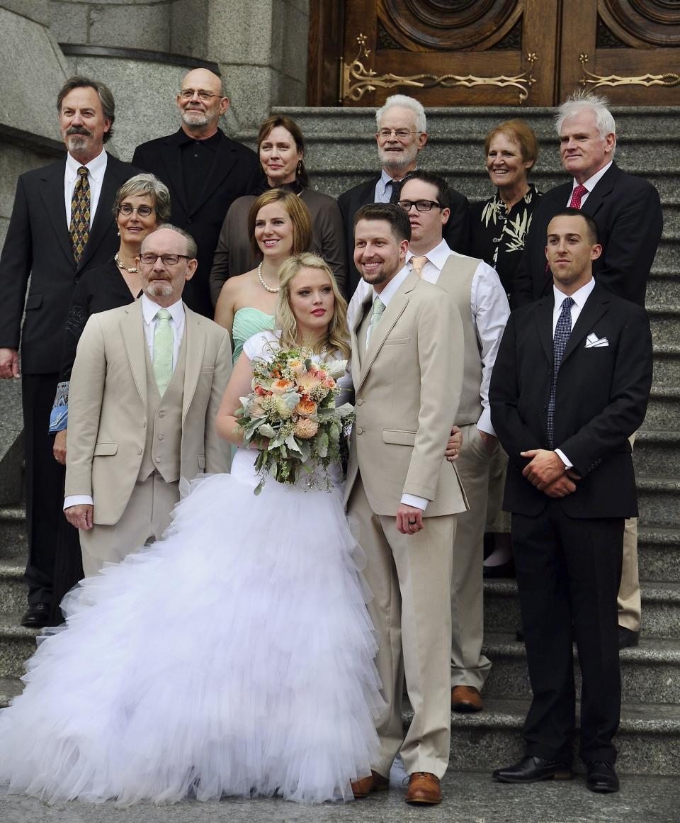 A newlywed couple poses for photographs with family members and friends after their wedding ceremony in Salt Lake City on Sept. 27, 2014. (Photo: Robert Alexander via Getty Images)