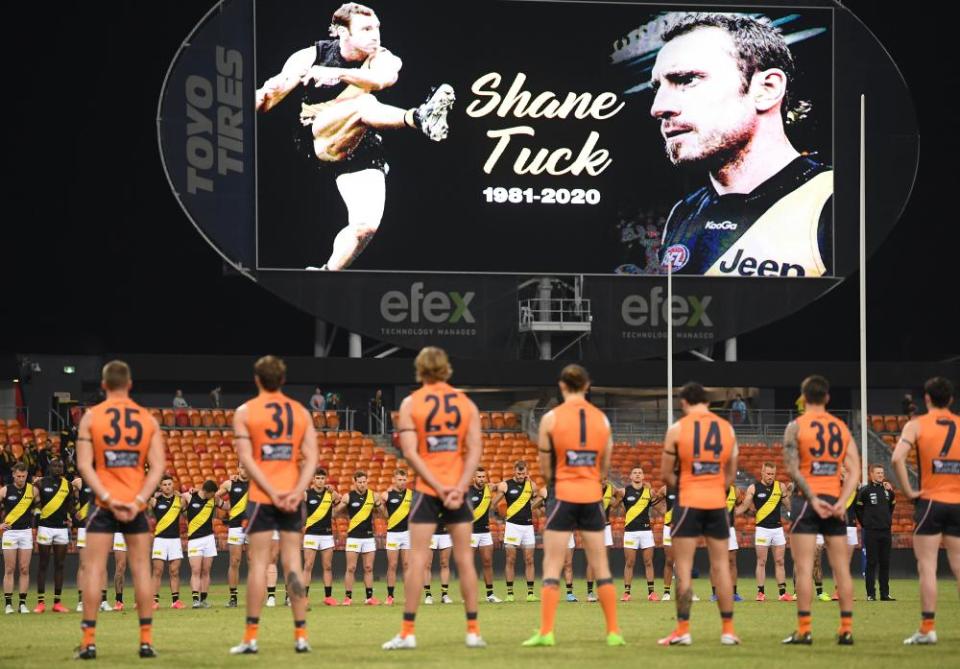 Richmond and GWS players observe a minute’s silence in memory of Shane Tuck.