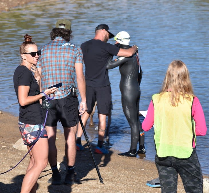 A swimmer checks in with her crew during the Mountain Man Invitational, the hardest triathlon