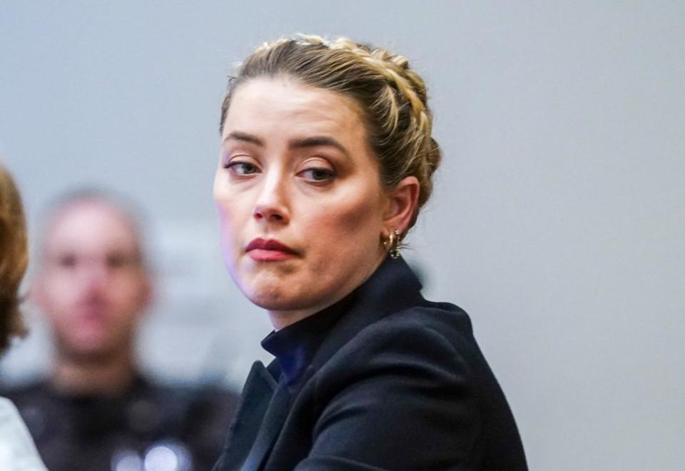 Amber Heard listens in the courtroom (AP)