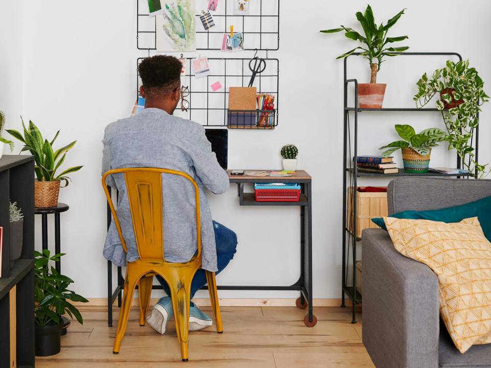 man working desk small space