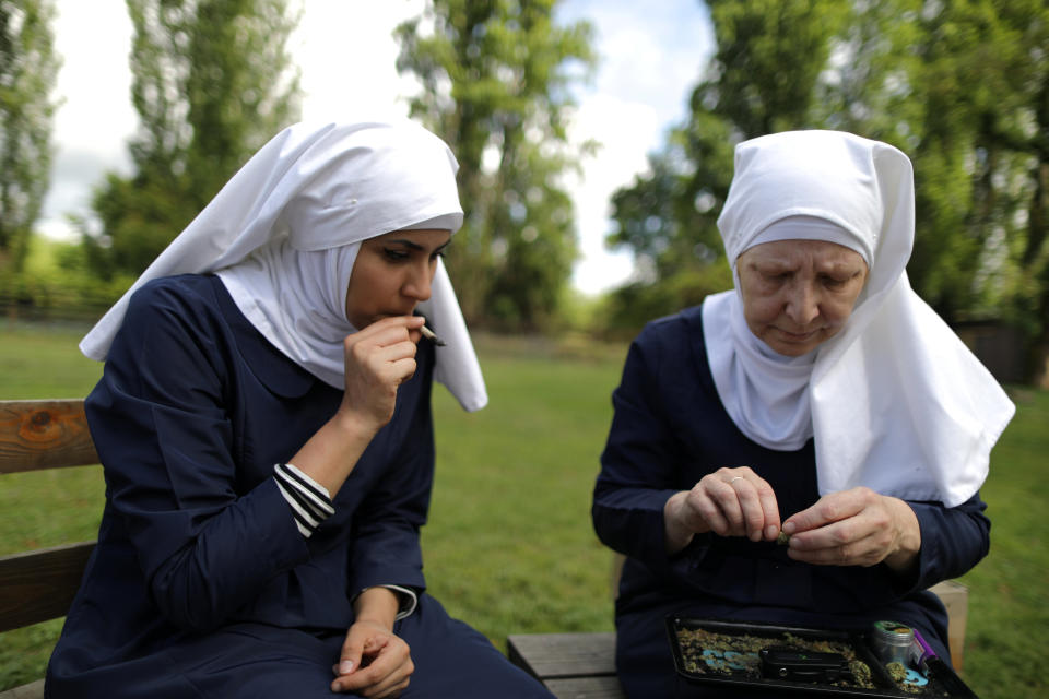 California "weed nun" Christine Meeusen, 57, (R), and India Delgado, who goes by the name Sister Eevee, smoke a joint at Sisters of the Valley near Merced, California, U.S., April 18, 2017. Picture taken April 18, 2017. REUTERS/Lucy Nicholson