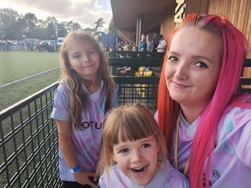 Group of three females looking at the camera