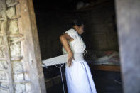 Lucia, a 44-year Arhuaco Indigenous woman, gets dressed at her home in Nabusimake on the Sierra Nevada de Santa Marta, Colombia, Tuesday, Jan. 17, 2023. Lucia works in Nabusimake as a nurse auxiliary. (AP Photo/Ivan Valencia)