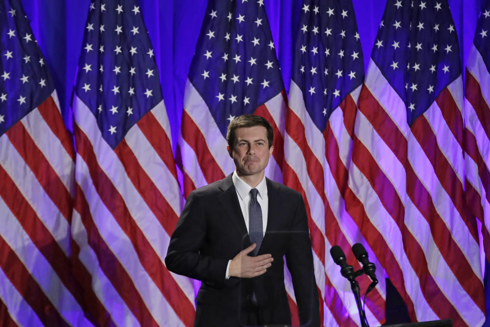 Pictured: Pete Buttigieg at a campaign event in 2019, in front of American flags. 