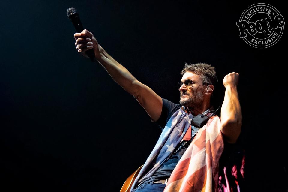 Church gathers scarfs handed to him by fans throughout the night, often winding up with several draped around his neck by the end of the show. On this particular night in Chicago, he would receive a patriotic scarf from a little girl sitting on her daddy's shoulders in the front row of the pit.