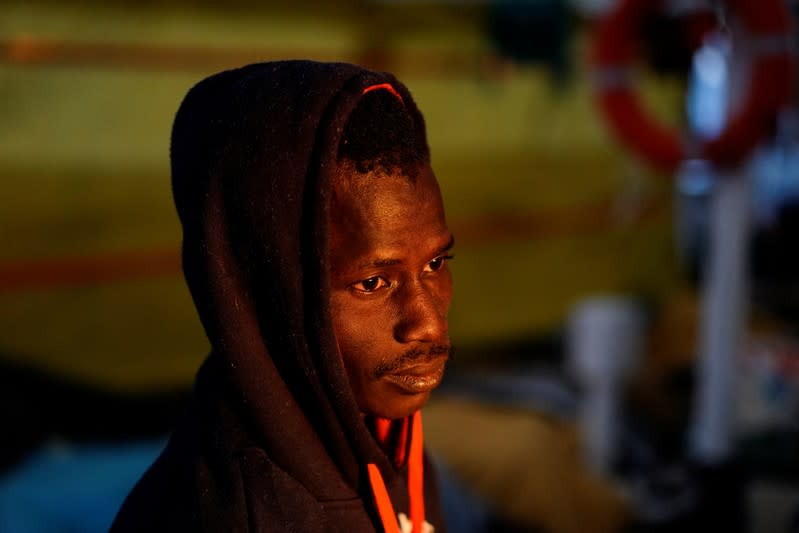 A migrant rests on board of NGO Proactiva Open Arms rescue boat in central Mediterranean Sea