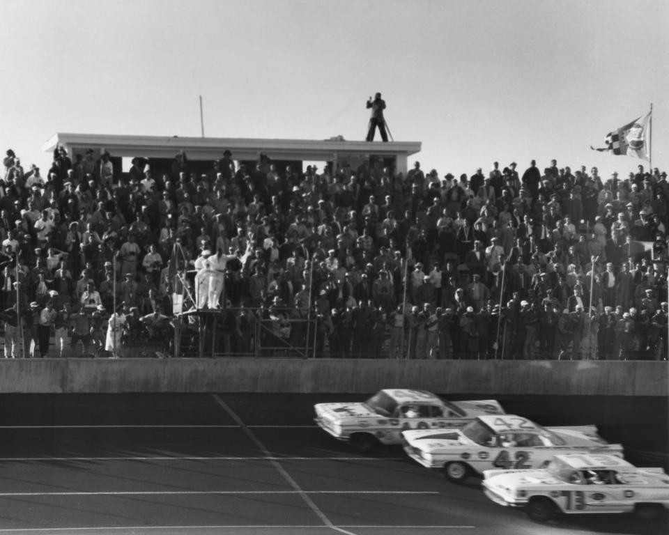 The finish of the first Daytona 500 in 1959. Johnny Beauchamp (73) was originally declared the winner over Lee Petty (42). Above them is the lapped car of Joe Weatherly.