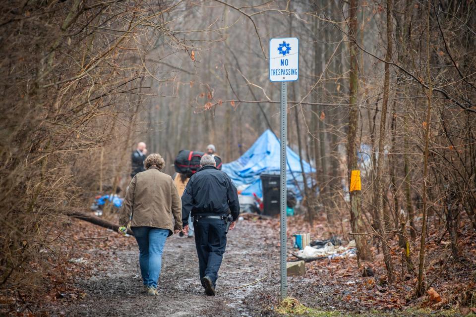 Mayor Kerry Thomson and Bloomington Police Chief Mike Diekhoff head into the encampment behind Wheeler Mission on Thursday.