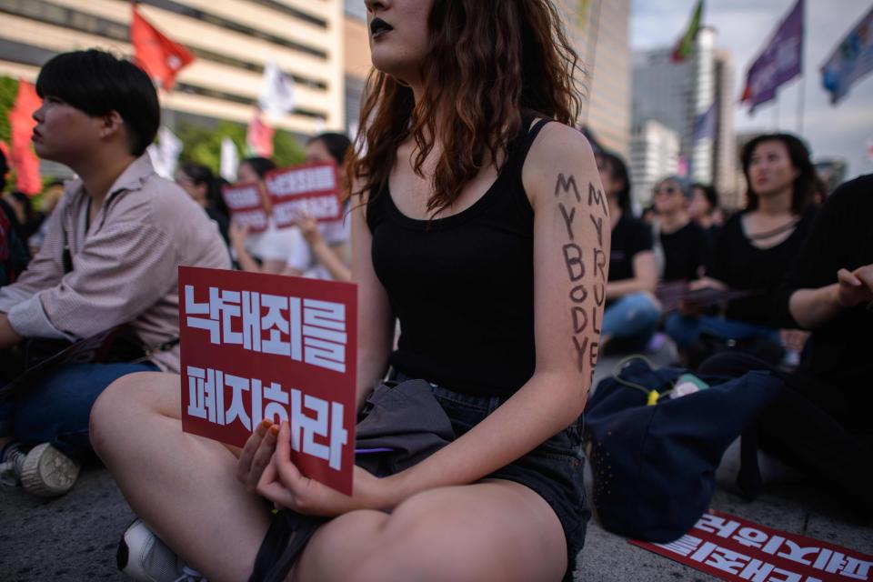 Protesters hold placards reading 'Abolish punishment for abortion' as they protest South Korean abortion laws in Gwanghwamun plaza in Seoul on July 7, 2018.