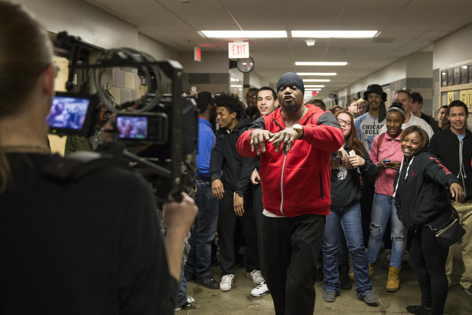 In this image provided by the Des Moines Public Schools, community activist and rap artist Will Keeps records a music video with students in a hallway at Des Moines Public School's Central Campus, on Jan. 29, 2016, in Des Moines, Iowa. Keeps is hospitalized in serious condition after surgery following just the sort of violence he's devoted his life to stop -- a shooting that killed two teenagers at the Starts Right Here educational program he founded in Des Moines. Keeps was hurt Monday, Jan. 23, 2023, when he tried to intervene. (Jon Lemons/Des Moines Public Schools via AP)