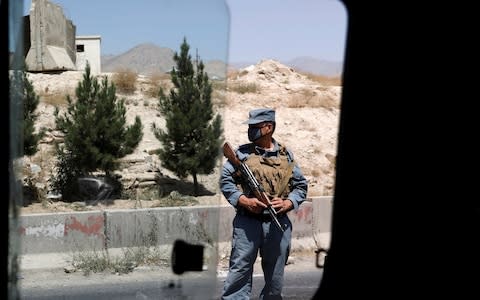 An Afghan policeman keeps watch at a checkpoint on the Ghazni highway, in Maidan Shar (file photo) - Credit: REUTERS/Mohammad Ismail