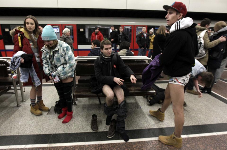 Passengers without their pants wait for a subway train during the "No Pants Subway Ride" event in Warsaw