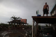 <p>A man stands on what is left of the balcony of his home and near another destroyed house, after the island was hit by Hurricane Maria in Toa Baja, Puerto Rico, Oct.16, 2017. (Photo: Alvin Baez/Reuters) </p>