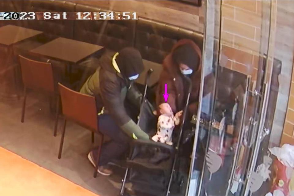 Constance Marten, Mark Gordon and baby Victoria in a shop in East Ham, London. This was shown in court during their trial (PA)