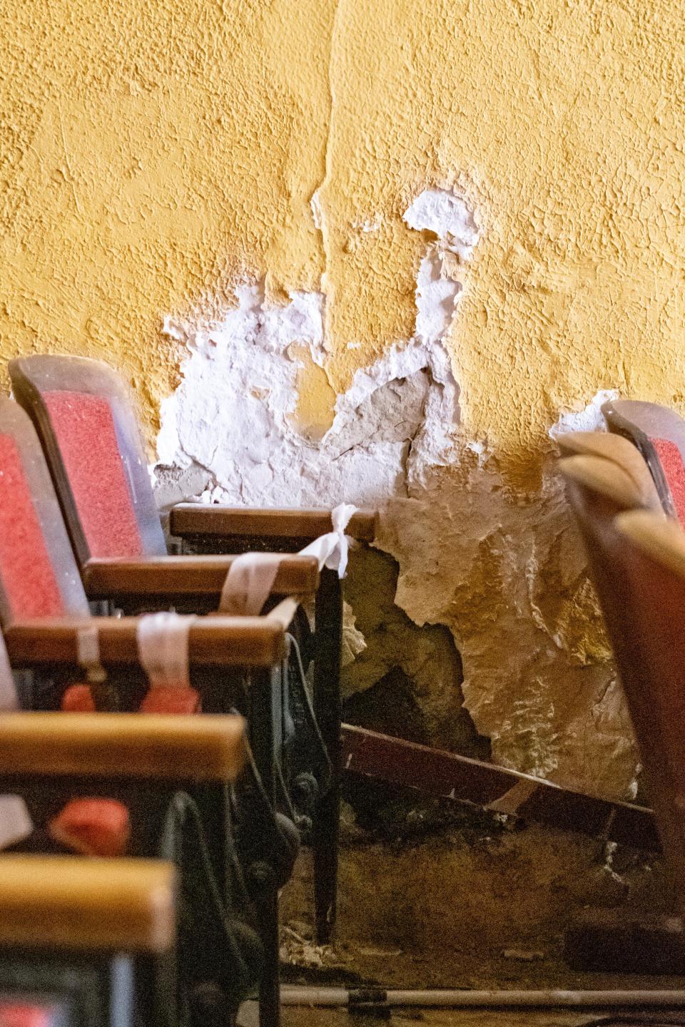 Water damage from the leaking roof is evident along the walls of the auditorium, requiring the blocking of adjacent seating at the Cambridge Performing Arts Center.