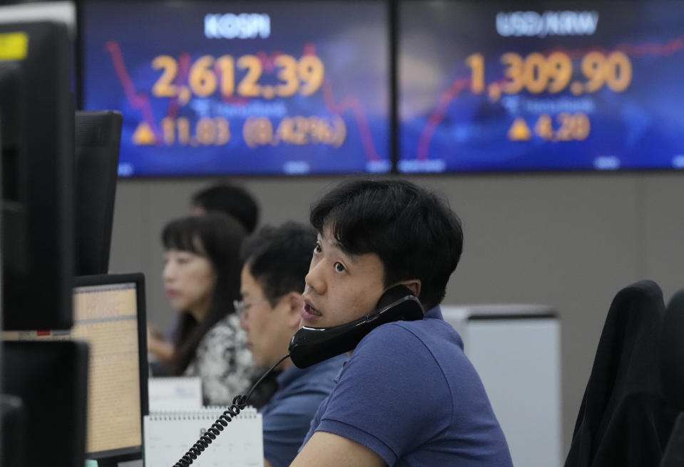 A currency trader watches monitors at the foreign exchange dealing room of the KEB Hana Bank headquarters in Seoul, South Korea, Monday, June 5, 2023. Asian stocks followed Wall Street higher on Monday after strong U.S. hiring data coupled with scant wage gains suggested a possible recession might be further away, but also that inflationary pressures are weakening. (AP Photo/Ahn Young-joon)