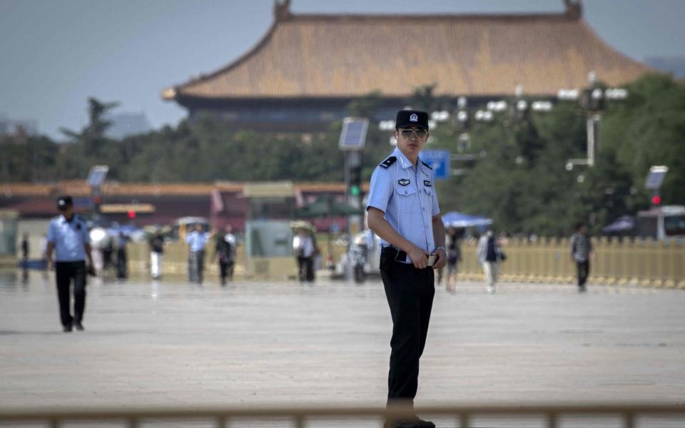 Police officers secure Tiananmen Square in Beijing, June 3, 2019 - AFP