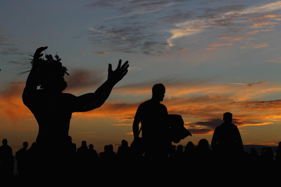 AMESBURY, ENGLAND - JUNE 20:  Solstice participants wait for the midsummer sun to rise over the megalithic monument of Stonehenge on June 20, 2010 on the edge of Salisbury Plain, west of Amesbury, England. (Photo by Matt Cardy/Getty Images)