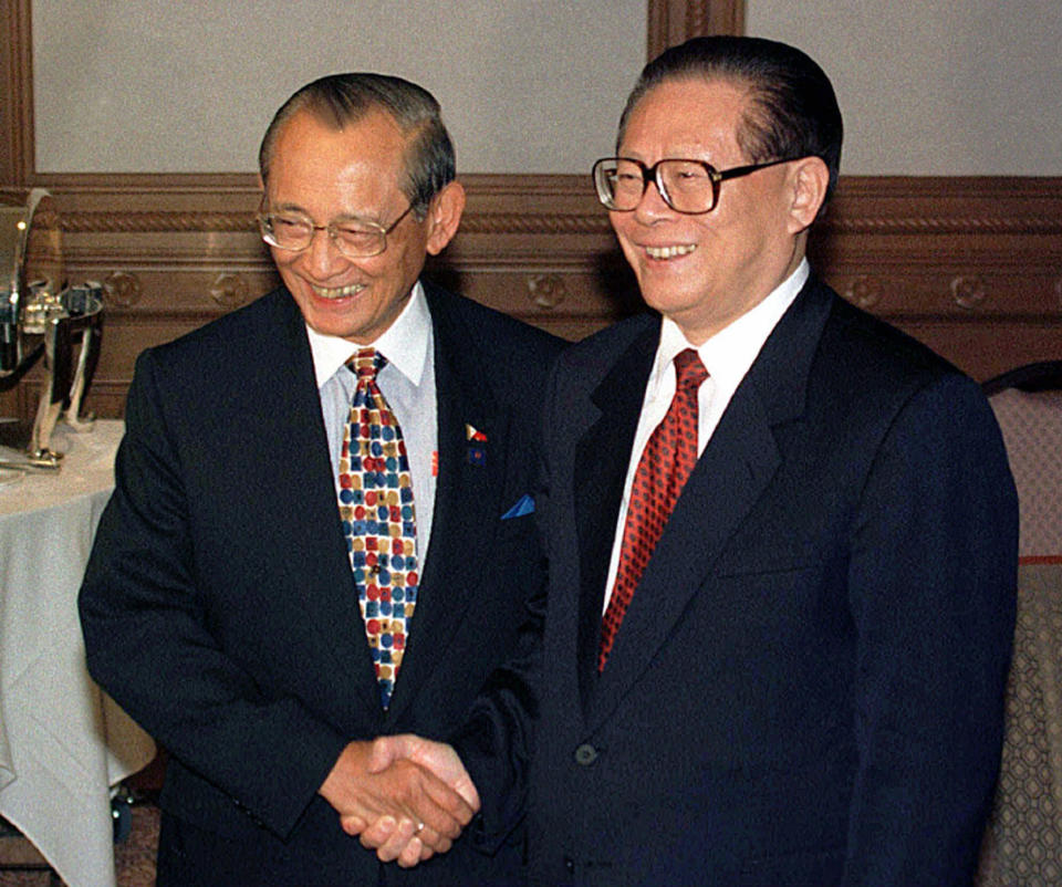 FILE - Philippine President Fidel Ramos, left, and his Chinese counterpart Jiang Zemin smile to photographers prior to their bilateral meeting at the Palace of the Golden Horses in Kuala Lumpur on Dec. 15, 1997. Ramos, a U.S.-trained ex-general who saw action in the Korean and Vietnam wars and played a key role in a 1986 pro-democracy uprising that ousted a dictator, has died. He was 94. Some of Ramos's relatives were with him when he died on Sunday, July 31, 2022, said his longtime aide Norman Legaspi. (AP Photo/Bullit Marquez, File)