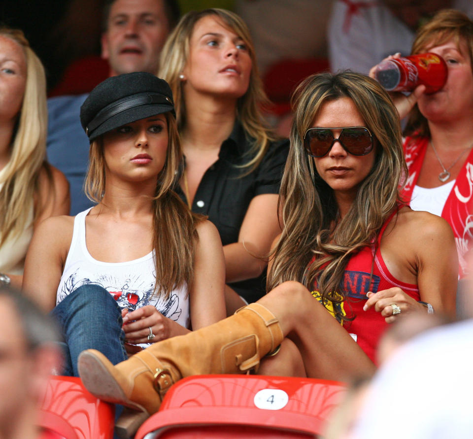 Cheryl Tweedy (L), girlfriend of England's Ashley Cole, sits in the stands with Victoria Beckham (R), wife of England's David Beckham, and Coleen McLoughlin (C Top), girlfriend of England's Wayne Rooney, before Trinidad and Tobago's Group B World Cup 2006 soccer match against England in Nuremberg June 15, 2006.  FIFA RESTRICTION - NO MOBILE USE     REUTERS/Kai Pfaffenbach     (GERMANY)