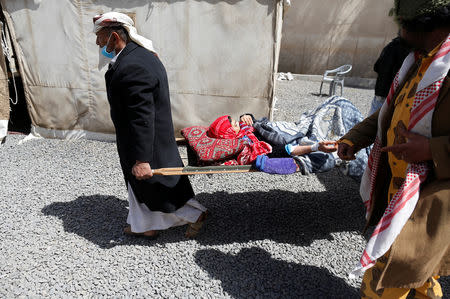 People carry a woman on a stretcher at a cholera treatment center in Sanaa, Yemen March 10, 2019. Picture taken March 10, 2019. REUTERS/Khaled Abdullah