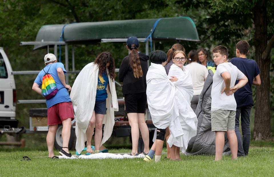 Kids keep warm in General Holm Park after two canoes capsized in the Jordan River in South Salt Lake on Tuesday, June 13, 2023. Seven kids and two counselors that were part of the Tracy Aviary summer youth group went into the water, but all made it safely to shore without any injuries. | Kristin Murphy, Deseret News