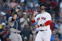 Boston Red Sox's J.D. Martinez, right, celebrates his solo home run in front of New York Yankees' Austin Romine during the fourth inning of a baseball game in Boston, Saturday, Aug. 4, 2018. (AP Photo/Michael Dwyer)