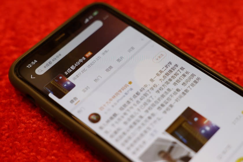 A phone displays the micro-blogging service Weibo with a post about the death of a 16-year-old Chinese student.