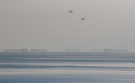 Russian jet fighters fly over vessels after the channel beneath a bridge connecting the Russian mainland with the Crimean Peninsula was blocked to stop three Ukrainian navy ships from entering the Sea of Azov via the Kerch Strait in the Black Sea, Crimea November 25, 2018. REUTERS/Pavel Rebrov